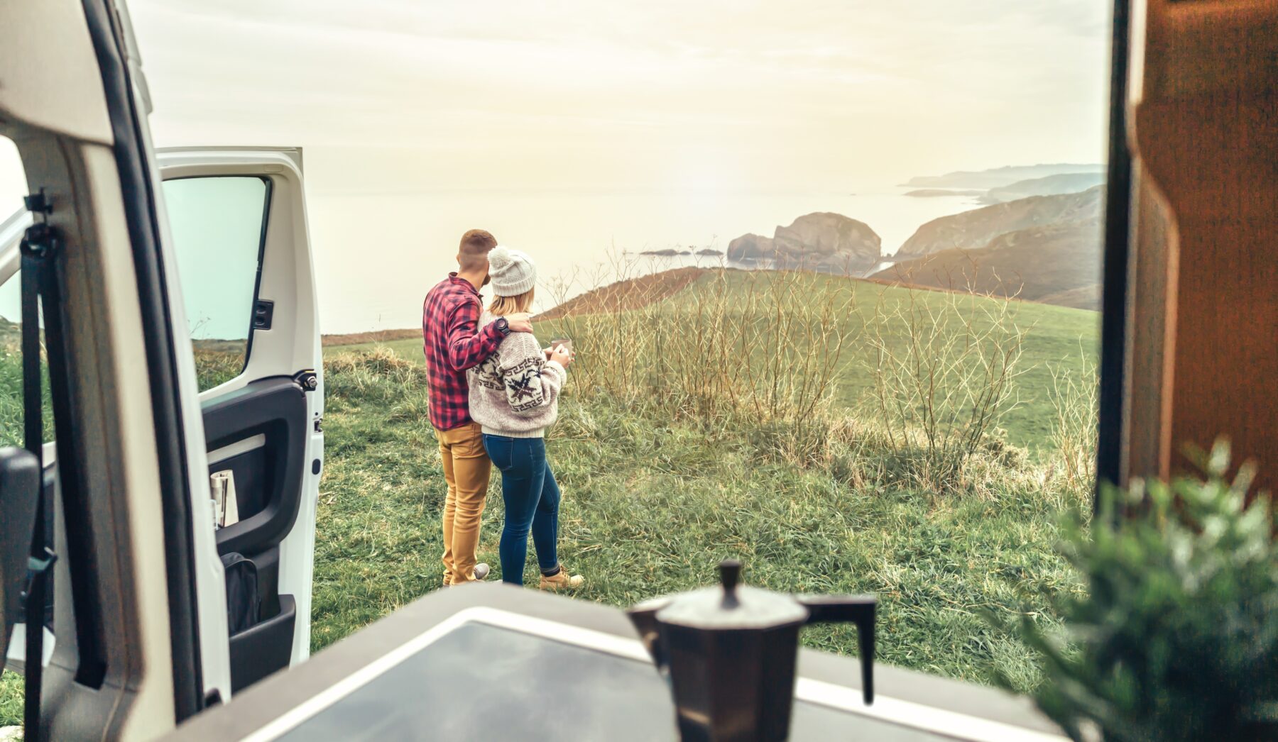 Unrecognizable,Couple,Traveling,In,Camper,Van,Looking,Coastline,Landscape,In